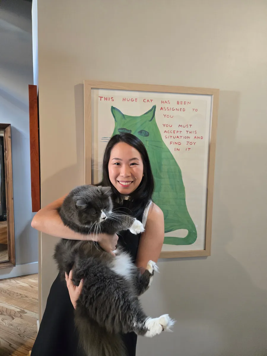 Jessica with Zuko the cat and her art